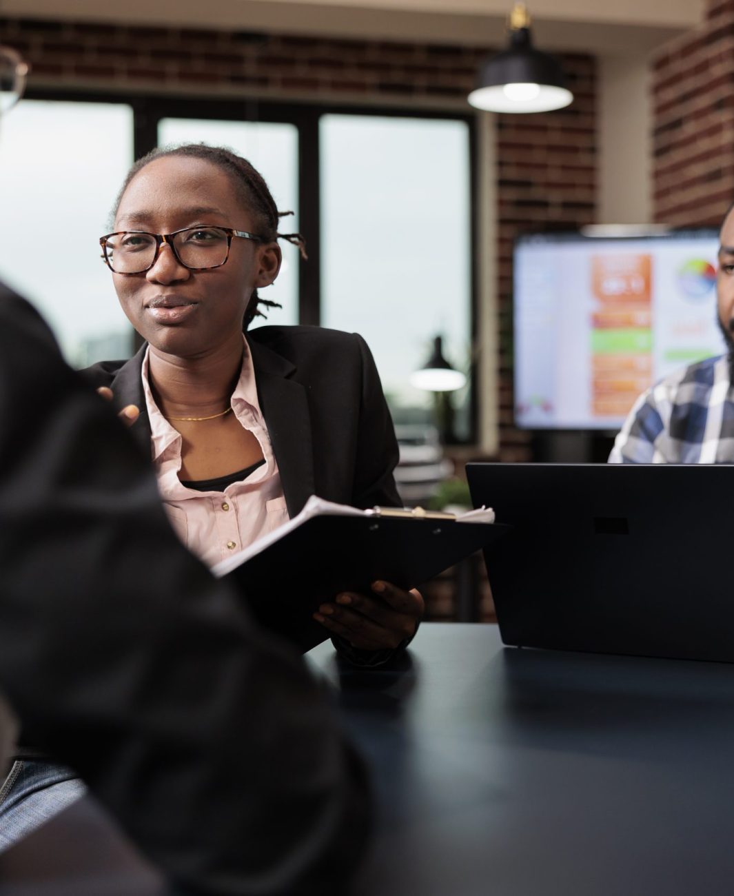 Colleagues team working on company paperwork, doig teamwork to analyze documents and online research information. Planning corporate presentation with data charts, job collaboration.